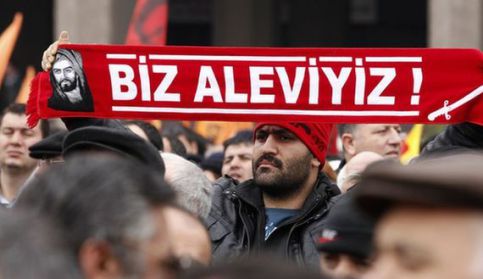 A Protester Holds A Banner Reading &Quot;We Are Alevi&Quot; As He And Many Others Wait To Hear The Decision Of The Court In Front Of A Courthouse In Ankara