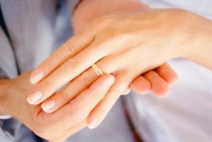 Groom Putting Wedding Ring on Bride's Finger