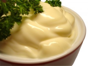 mayonnaise in red line sauce-boat with curly parsl